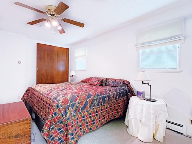 bedroom featuring a ceiling fan, carpet flooring, baseboard heating, and a closet