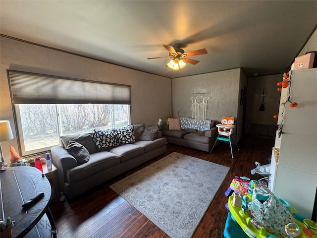 living room featuring a ceiling fan and wood finished floors