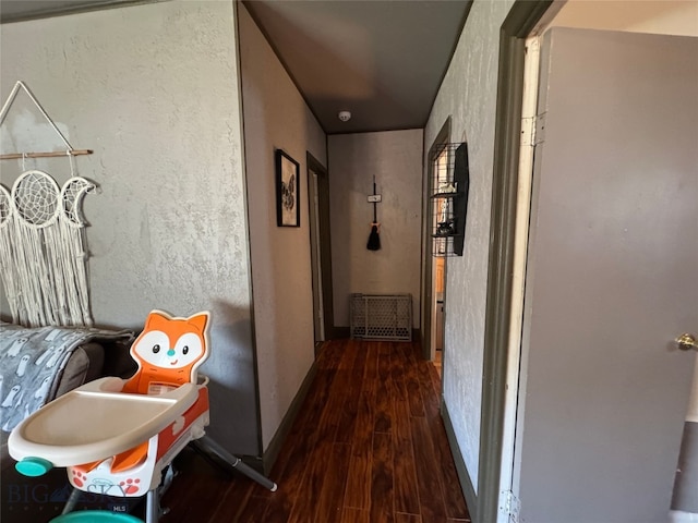 hall with baseboards and wood finished floors