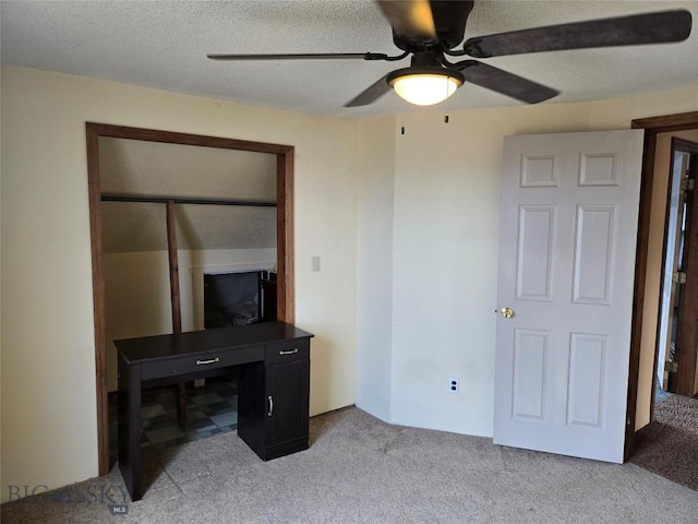 interior space with ceiling fan, a closet, and light carpet