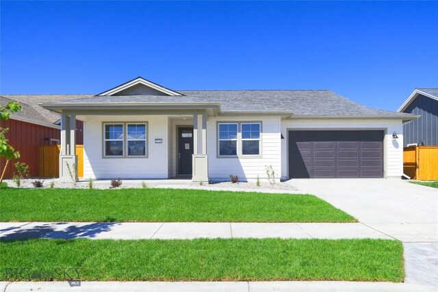 1520 Cyril Way, Belgrade, MT 59714 - ranch-style home featuring an attached garage, concrete driveway, covered porch, and roof with shingles