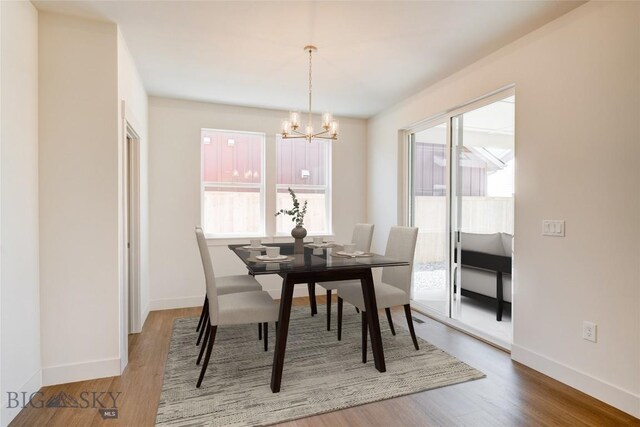1520 Cyril Way, Belgrade, MT 59714 - dining space featuring plenty of natural light, a chandelier, and wood finished floors