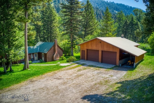 14470 Cottonwood Canyon Rd, Bozeman, MT 59718 - garage featuring a detached garage and a forest view
