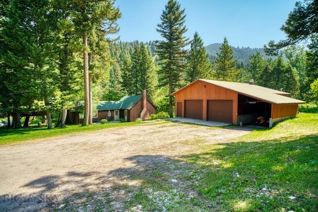 14470 Cottonwood Canyon Rd, Bozeman, MT 59718 - garage featuring a forest view and a garage