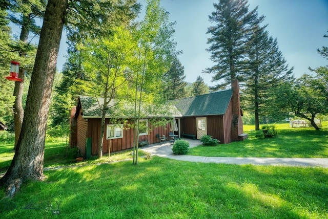 14470 Cottonwood Canyon Rd, Bozeman, MT 59718 - exterior space with a yard, a chimney, roof with shingles, and board and batten siding
