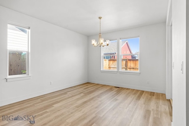 1511 Masterson, Belgrade, MT 59714 - spare room with light wood-type flooring and a chandelier