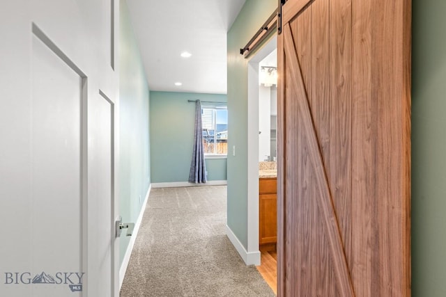 1511 Masterson, Belgrade, MT 59714 - corridor with a barn door, light colored carpet, and recessed lighting