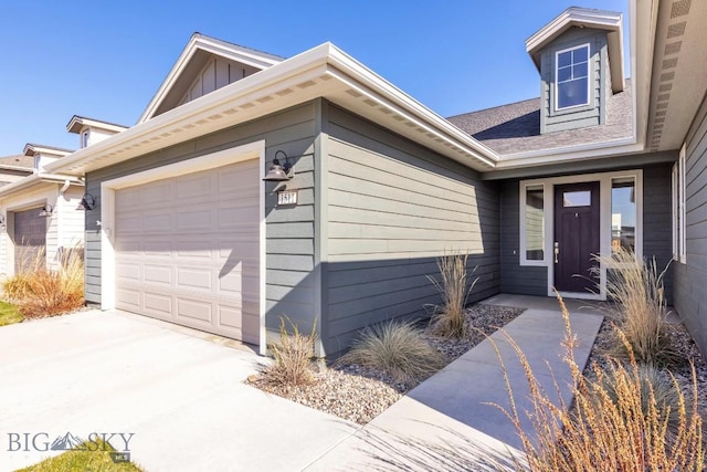1511 Masterson, Belgrade, MT 59714 - exterior space featuring a garage, board and batten siding, and driveway