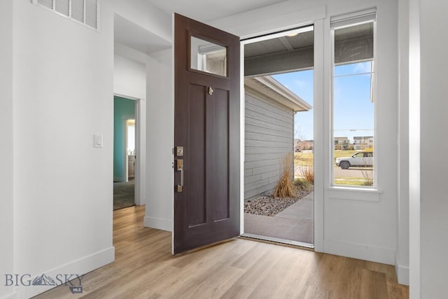 1511 Masterson, Belgrade, MT 59714 - doorway featuring baseboards, visible vents, and light wood-style floors