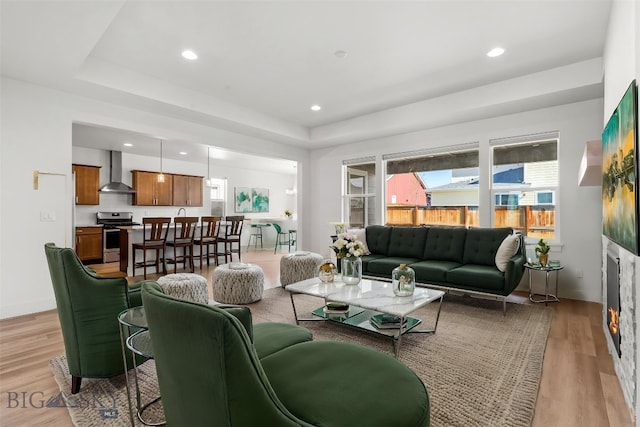 1511 Masterson, Belgrade, MT 59714 - living area with light wood-type flooring, a raised ceiling, and recessed lighting
