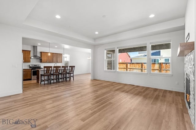 1511 Masterson, Belgrade, MT 59714 - living area featuring light wood-style floors, plenty of natural light, recessed lighting, and a stone fireplace