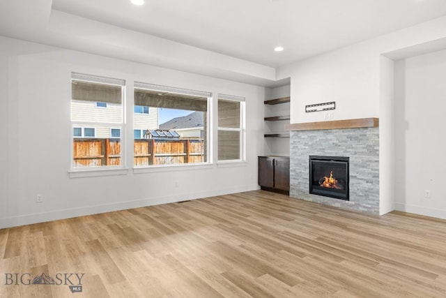 1511 Masterson, Belgrade, MT 59714 - unfurnished living room with baseboards, recessed lighting, a stone fireplace, and light wood finished floors