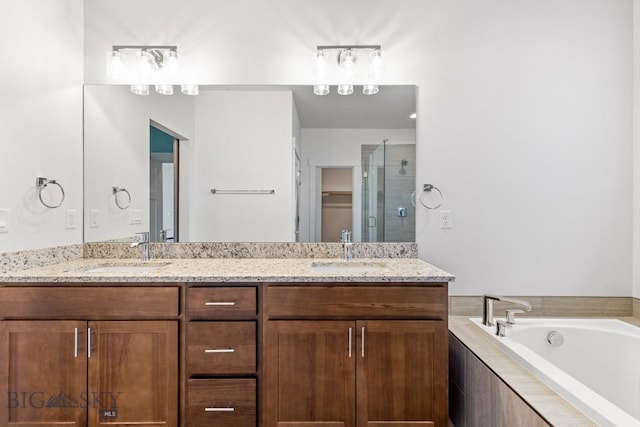 1511 Masterson, Belgrade, MT 59714 - full bathroom with double vanity, a garden tub, a shower stall, and a sink