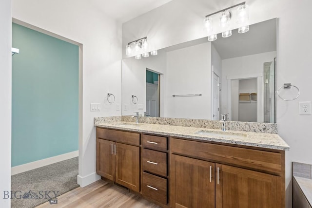 1511 Masterson, Belgrade, MT 59714 - bathroom with double vanity, wood finished floors, and a closet