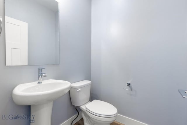 1511 Masterson, Belgrade, MT 59714 - bathroom with a sink, toilet, and baseboards