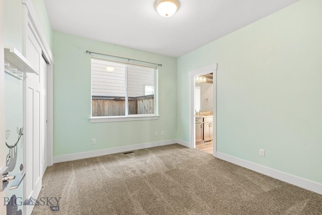 1511 Masterson, Belgrade, MT 59714 - unfurnished bedroom with ensuite bathroom, a closet, carpet, and baseboards