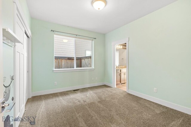 1511 Masterson, Belgrade, MT 59714 - unfurnished bedroom with carpet floors, ensuite bathroom, and a closet