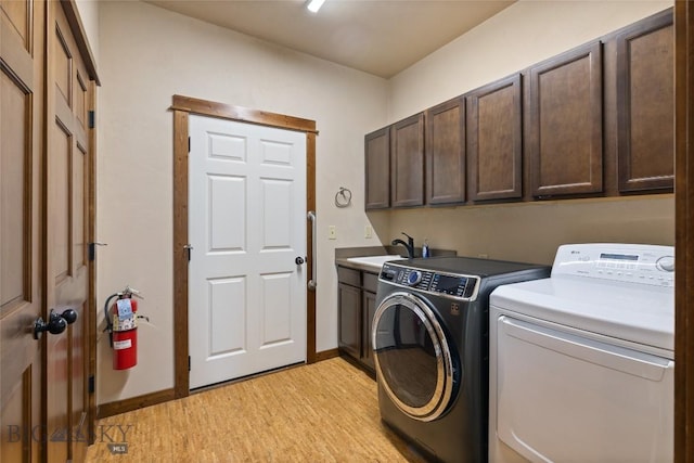 3383 Sora Way, Bozeman, MT 59718 - washroom with cabinet space, washer and dryer, and light wood finished floors