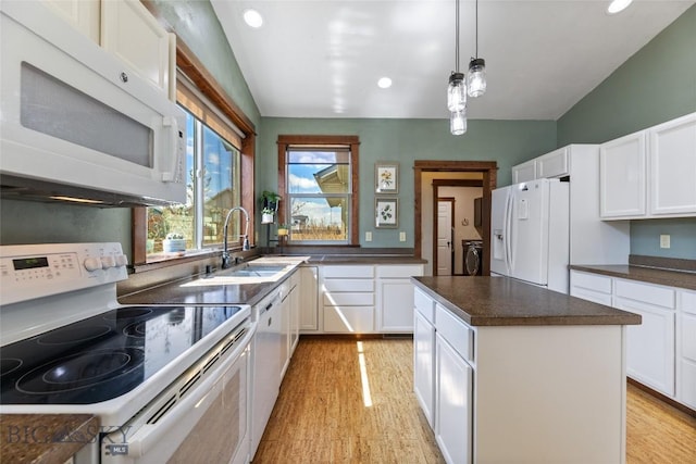 3383 Sora Way, Bozeman, MT 59718 - kitchen with white appliances, washer and clothes dryer, light wood-type flooring, dark countertops, and white cabinets