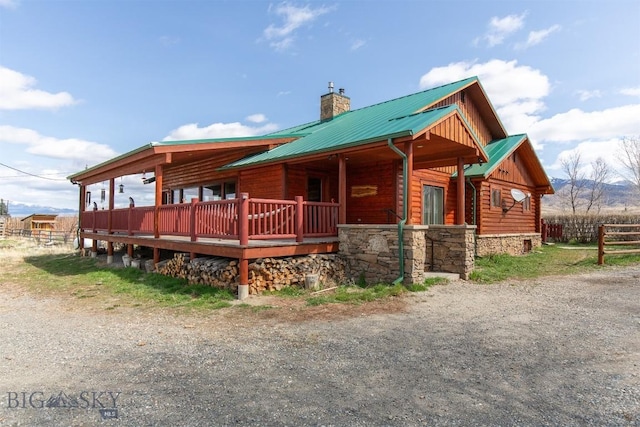 18 7m4r Rd, Sheridan, MT 59749 - log cabin featuring a chimney, a metal roof, and stone siding