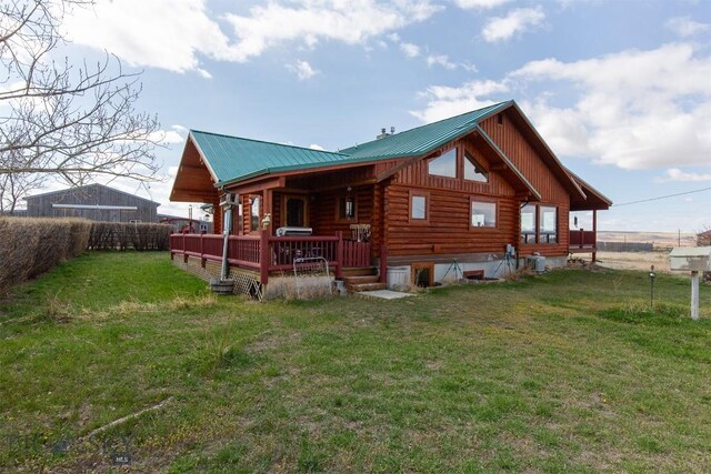 18 7m4r Rd, Sheridan, MT 59749 - back of property with log siding, board and batten siding, a metal roof, and a porch