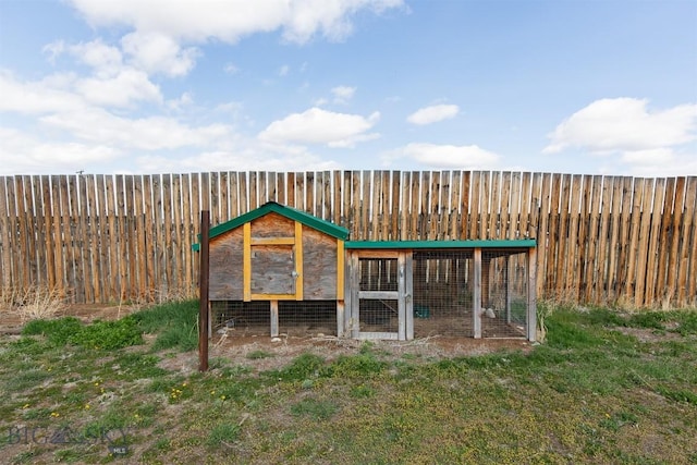 view of poultry coop featuring fence