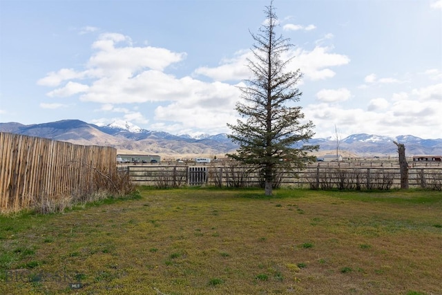 view of yard with a mountain view and fence