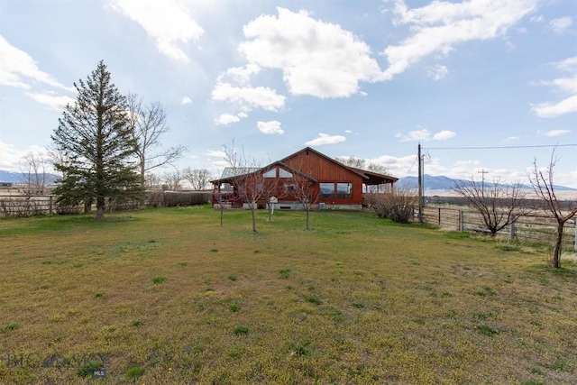 view of yard with a rural view and fence