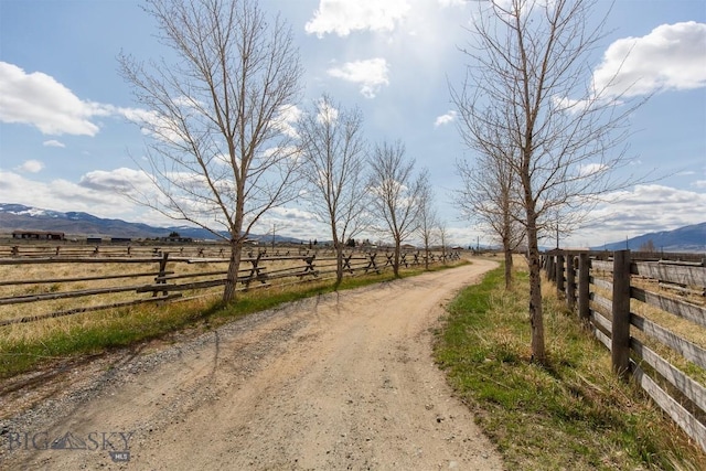 view of street with a rural view and a mountain view