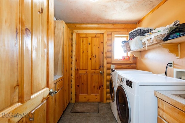 laundry area with rustic walls, cabinet space, washing machine and clothes dryer, and tile patterned flooring