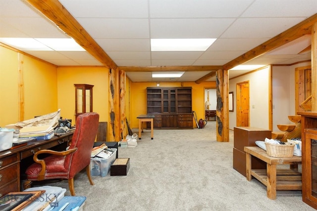 interior space featuring a paneled ceiling and carpet flooring