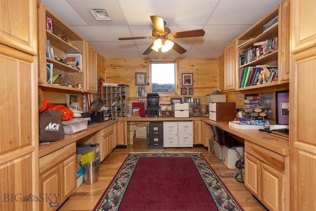 office with light wood-style flooring, built in study area, ceiling fan, and a drop ceiling