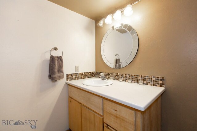 bathroom with vanity and backsplash