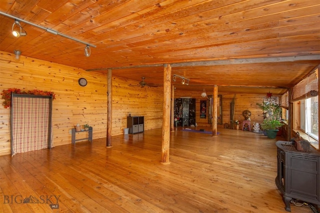 miscellaneous room with wood ceiling, wood walls, light wood-type flooring, track lighting, and a ceiling fan