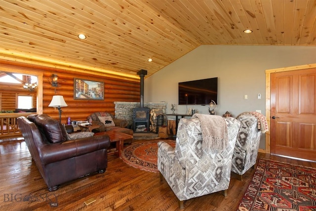 living room with a wood stove, wood finished floors, log walls, and wood ceiling