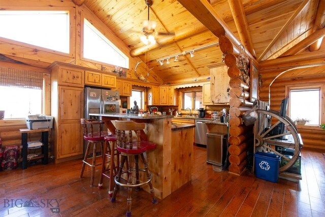 18 7m4r Rd, Sheridan, MT 59749 - kitchen with a wooden ceiling with exposed beams, high vaulted ceiling, dark wood-style floors, brown cabinetry, and a breakfast bar area