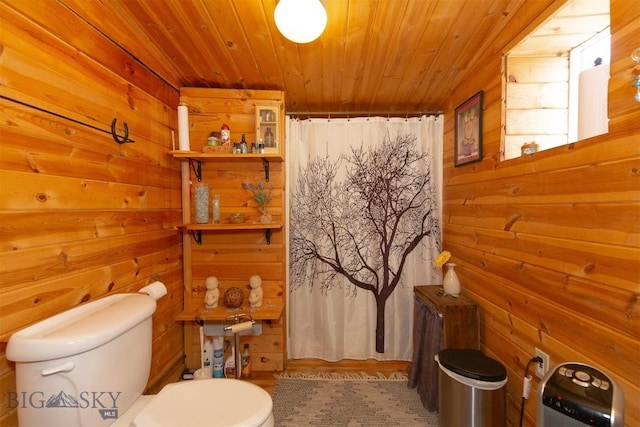 bathroom with wood walls, toilet, curtained shower, and wood ceiling