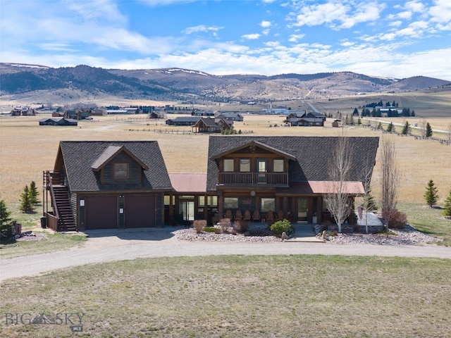6 Browtine Ln, Ennis, MT 59729 - view of front facade with covered porch, a mountain view, driveway, and an attached garage