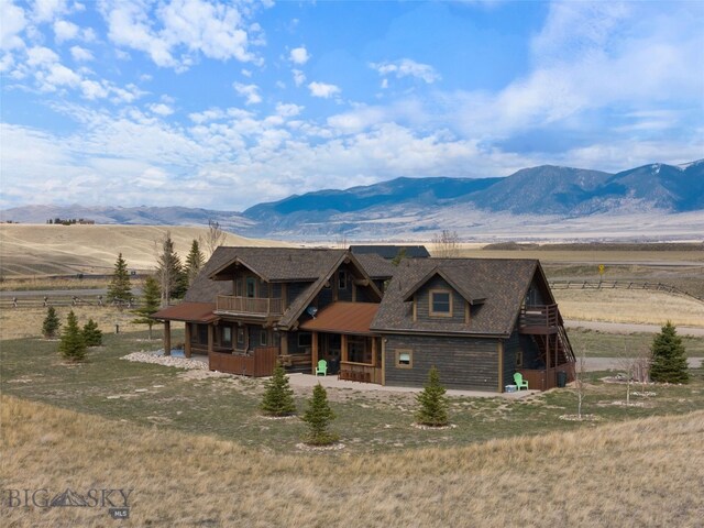 6 Browtine Ln, Ennis, MT 59729 - view of front of house featuring a mountain view, covered porch, and a balcony