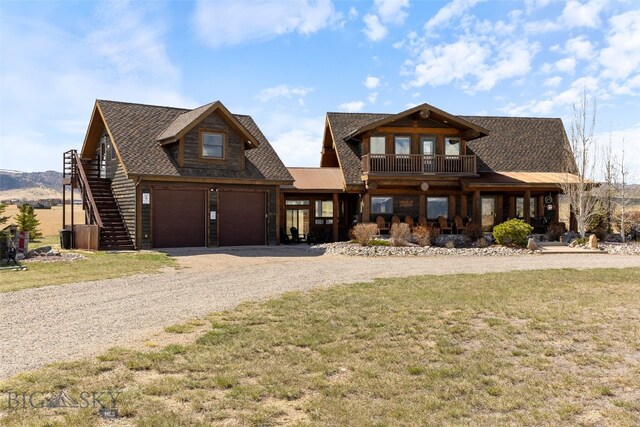 6 Browtine Ln, Ennis, MT 59729 - view of front of house featuring driveway, stairs, a shingled roof, a front yard, and a garage