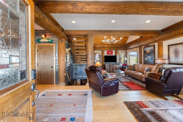 6 Browtine Ln, Ennis, MT 59729 - living area with beam ceiling, log walls, hardwood / wood-style floors, and a notable chandelier