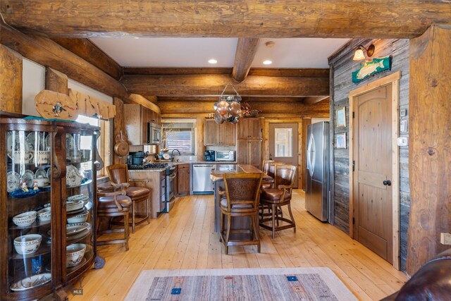 6 Browtine Ln, Ennis, MT 59729 - kitchen featuring brown cabinets, stainless steel appliances, beam ceiling, an inviting chandelier, and light wood-type flooring