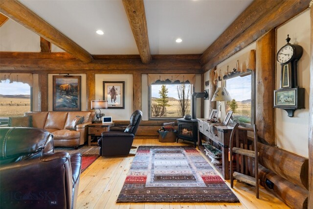6 Browtine Ln, Ennis, MT 59729 - living area featuring beamed ceiling, a wood stove, recessed lighting, and hardwood / wood-style floors