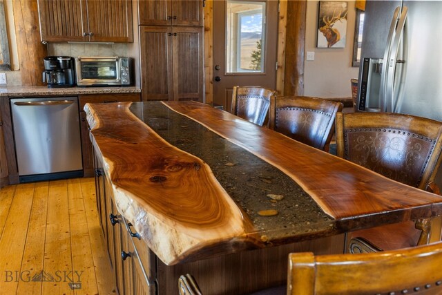 6 Browtine Ln, Ennis, MT 59729 - kitchen with light wood-style flooring, brown cabinetry, stainless steel appliances, a toaster, and wooden counters