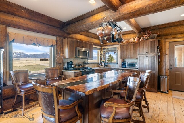 6 Browtine Ln, Ennis, MT 59729 - kitchen featuring stainless steel microwave, light wood-style flooring, a sink, butcher block countertops, and gas stove