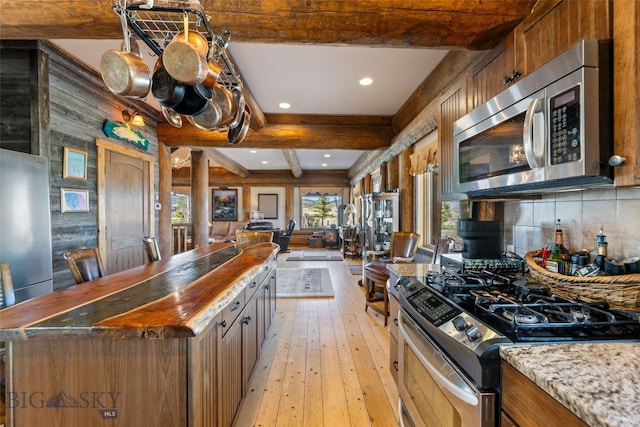 6 Browtine Ln, Ennis, MT 59729 - kitchen with light wood finished floors, recessed lighting, beam ceiling, appliances with stainless steel finishes, and open floor plan