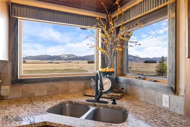 6 Browtine Ln, Ennis, MT 59729 - room details featuring tasteful backsplash, light stone counters, a mountain view, and a sink