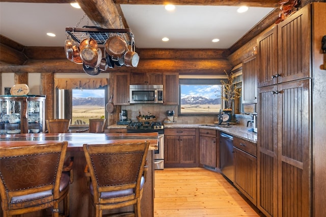 6 Browtine Ln, Ennis, MT 59729 - kitchen with tasteful backsplash, recessed lighting, light wood-style floors, appliances with stainless steel finishes, and a sink