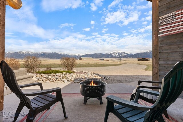 6 Browtine Ln, Ennis, MT 59729 - view of patio / terrace with a mountain view and an outdoor fire pit