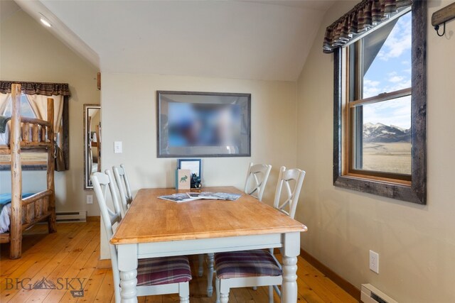 6 Browtine Ln, Ennis, MT 59729 - dining area with a baseboard heating unit, light wood finished floors, vaulted ceiling, and baseboards